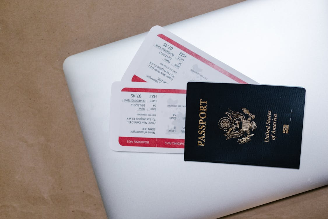 A US passport and boarding pass on a laptop